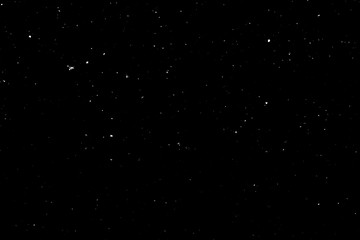 WHITE BOKEH ON A BLACK BACKGROUND. LIGHT SPOTS TEXTURE. FALLING SNOW. STAR SKY.