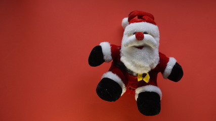 teddy bear as santa claus in a red background