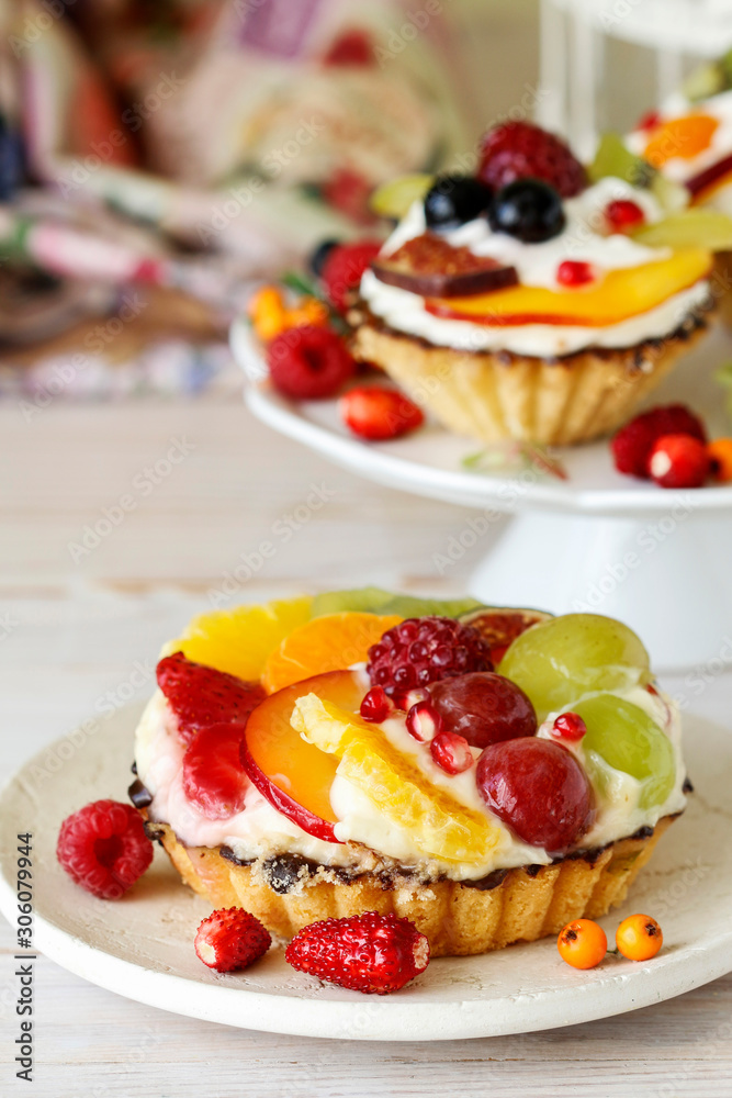 Poster colorful cupcakes with fresh fruits.