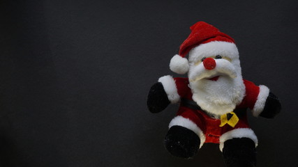 teddy bear as santa claus in a black background