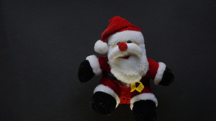 teddy bear as santa claus in a black background