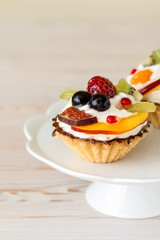 Colorful cupcakes with fresh fruits.