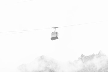Funicular with cable car among misty foggy highland
