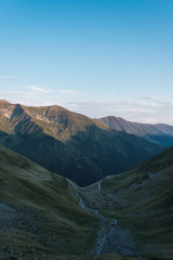 Empty green valley with big hills and blue sky