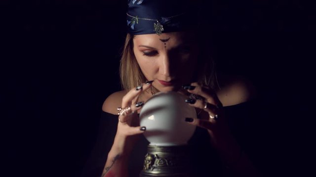 4k Mysterious Shot of Fortune Teller Posing with Hands on Orb