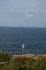 White yacht sailing in ocean in summer