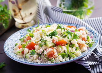 Traditional Lebanese Salad Tabbouleh. Couscous with parsley, tomato, cucumber, lemon and olive oil. Middle Eastern cuisine.