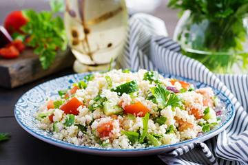 Traditional Lebanese Salad Tabbouleh. Couscous with parsley, tomato, cucumber, lemon and olive oil. Middle Eastern cuisine.