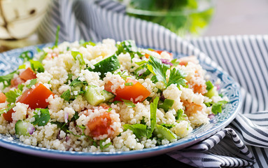 Traditional Lebanese Salad Tabbouleh. Couscous with parsley, tomato, cucumber, lemon and olive oil....