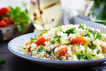 Traditional Lebanese Salad Tabbouleh. Couscous with parsley, tomato, cucumber, lemon and olive oil. Middle Eastern cuisine.