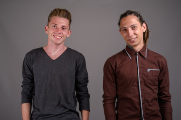 Young man with dreadlocks and young man with blond hair against