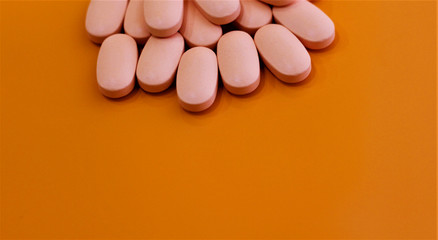 vitamin pills on orange background