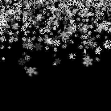 Snowfall background with snowflakes blurred in the dark