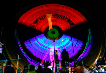 Spinning ferris wheel at night.