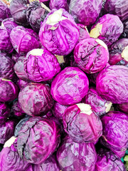Fototapeta na wymiar Purple cabbage stacked at the farmers market