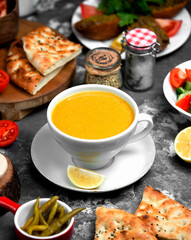lentil soup in cup served with lemon