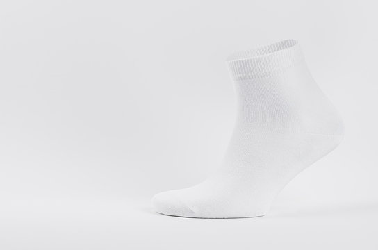Blank white cotton medium sock on invisible  foot on white background as mock up for advertising, branding, design, side view, template.