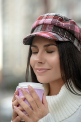 Happy dark haired woman smelling her delicious coffee
