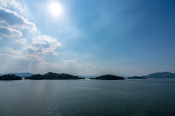 beautiful blue sky green forest mountains lake view at Kaeng Krachan National Park, Thailand.  an idea for backpacker hiking on long weekend or a couple, family holiday activity camping relaxing