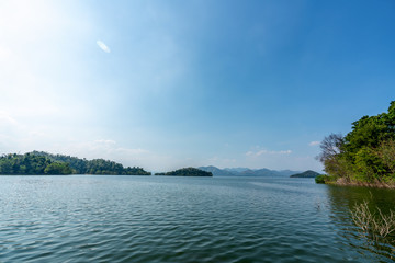 beautiful blue sky green forest mountains lake view at Kaeng Krachan National Park, Thailand.  an idea for backpacker hiking on long weekend or a couple, family holiday activity camping relaxing