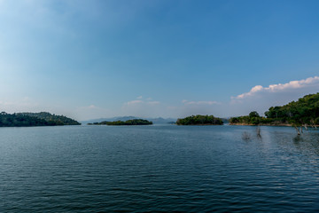 beautiful blue sky green forest mountains lake view at Kaeng Krachan National Park, Thailand.  an idea for backpacker hiking on long weekend or a couple, family holiday activity camping relaxing