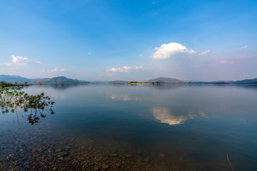 beautiful blue sky green forest mountains lake view at Kaeng Krachan National Park, Thailand.  an idea for backpacker hiking on long weekend or a couple, family holiday activity camping relaxing