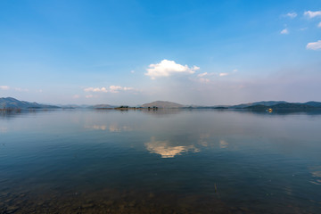 beautiful blue sky green forest mountains lake view at Kaeng Krachan National Park, Thailand.  an idea for backpacker hiking on long weekend or a couple, family holiday activity camping relaxing