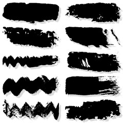 Strokes with a dry brush. Vector texture of paint spots. Set of grunge blots. The template for the background. Black ink isolated on white