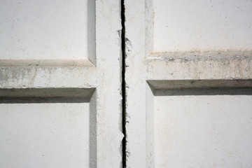 White concrete wall of the Soviet era. The junction between the plates. Fragment of the wall.