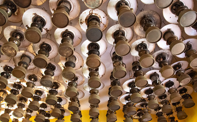 Antique kerosene lamps lined hanging on the ceiling.