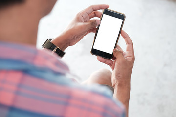Mockup smartphone of man’s holding black mobile phone with white screen in his office.