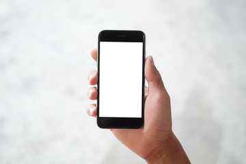 Mockup smartphone of man’s holding black mobile phone with white screen in his office.