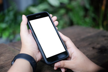 Mockup smartphone of man’s holding black mobile phone with white screen in his office.