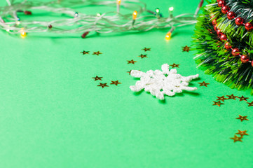 Christmas decoration on the green background. Ornaments, snowflakes, stars. Christmas tree.