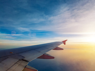 Fototapeta na wymiar sunset sky as seen through window of airplane, plane window. travel and vacation concept