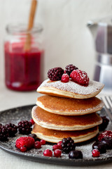 Pancakes with blackberries, raspberries and red currants. American cuisine.