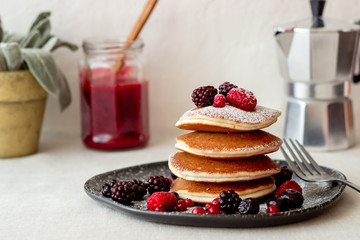 Pancakes with blackberries, raspberries and red currants. American cuisine.