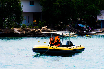 Fototapeta premium Motorized boat, floating in the water On the boat there is a life jacket.