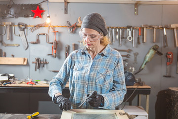 Carpenter working on the old wood in a retro vintage workshop.