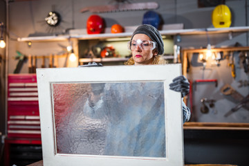 Carpenter working on the old wood in a retro vintage workshop.