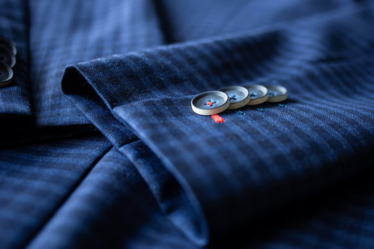 Buttons arranged on the sleeves of the blue suit. The sleeves of the shirt are blue.