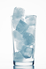 one glass of water full of ice cubes, white background, blue toned object