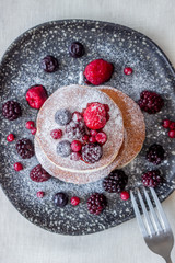 Pancakes with blackberries, raspberries and red currants. American cuisine.