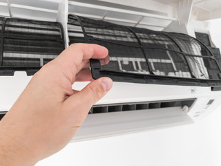 Modern airconditioner unit service cleaning the filter to prevent respiratory disease.
