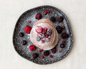 Pancakes with blackberries, raspberries and red currants. American cuisine.