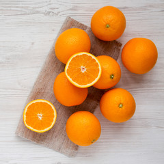 Fresh ripe organic oranges on a white wooden table, top view. Flat lay, overhead, from above.