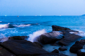 The rocks on the beach and the incoming sea water. And the sea and sky background