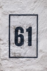 black number 61 on white wall