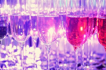 Rows of full champagne, sparkling wine and red wine glasses. Dining, drink. Catering service concept.