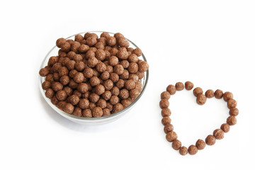 corn brown balls in a glass plate and a heart-shaped pattern for valentines day